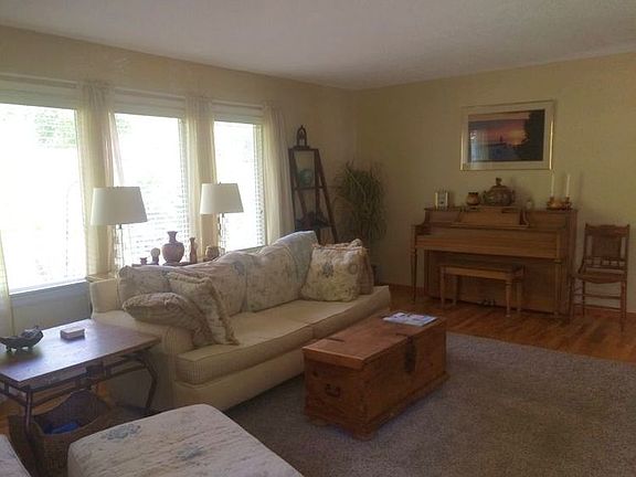 Bright and cheery Living Room with large windows and gorgeous oak hardwood floors