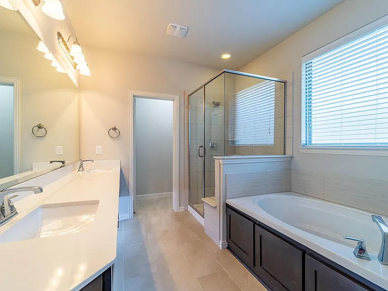 Separate garden tub and roomy shower with seat