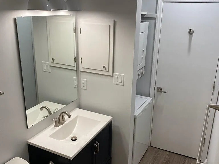 Second bedroom with washed dryer and full sized shower/tub.