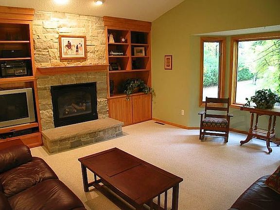 Upper family room with gas fireplace and vaulted ceiling