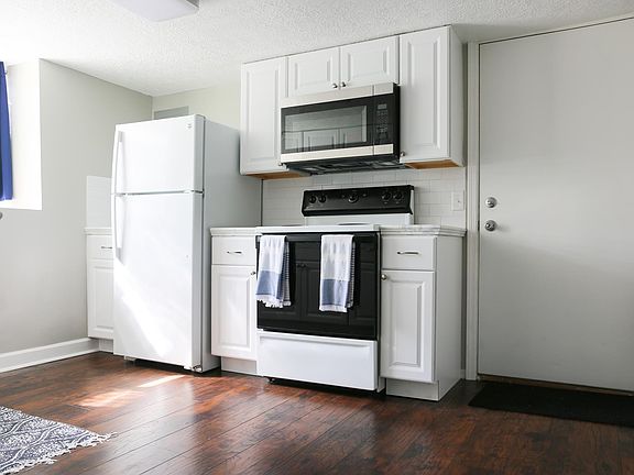 Updated flooring, cabinets and countertops in newly remodeled kitchen
