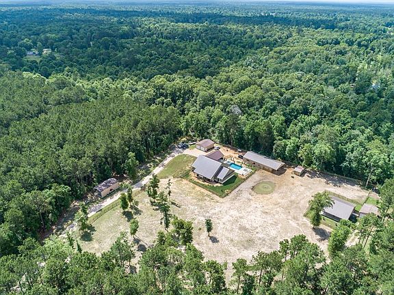Your property includes (photo center) the Main House, Pool/Spa and Outdoor Living, 2-Car Garage, 70x30 Barn & Stable, Pump House (well/aerobic sewer), pond w/fountain. It also includes RV parking (photo left) and a 720 sqft Guest Cottage with separat