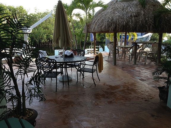 Patio with hot tub overlooking waterway