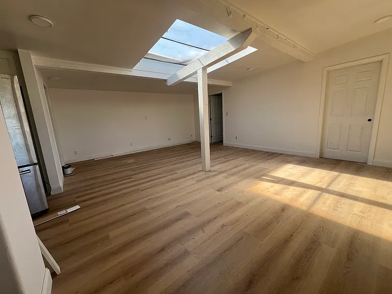 living room looking at 2 bedrooms. kitchen and bathroom off to the left