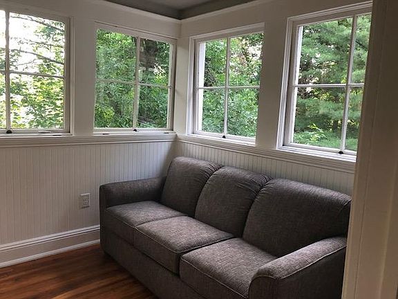 Couch in sunroom converts into queen sofabed