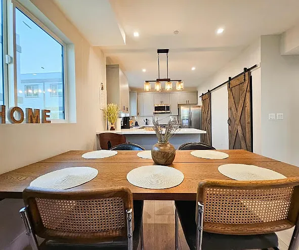 Dining + Kitchen View Open-concept dining and kitchen area with modern finishes and a spacious, inviting layout.