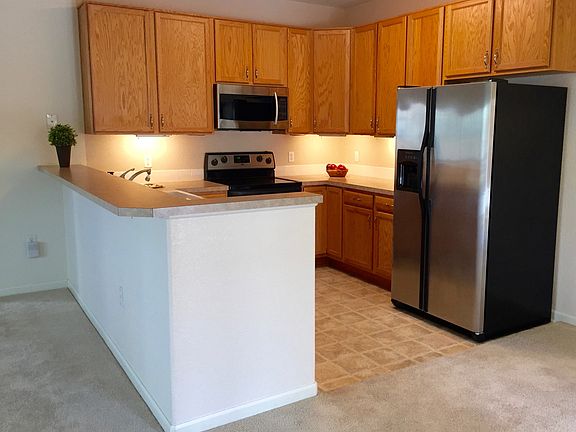 Kitchen with under cabinet lighting and SS appliances