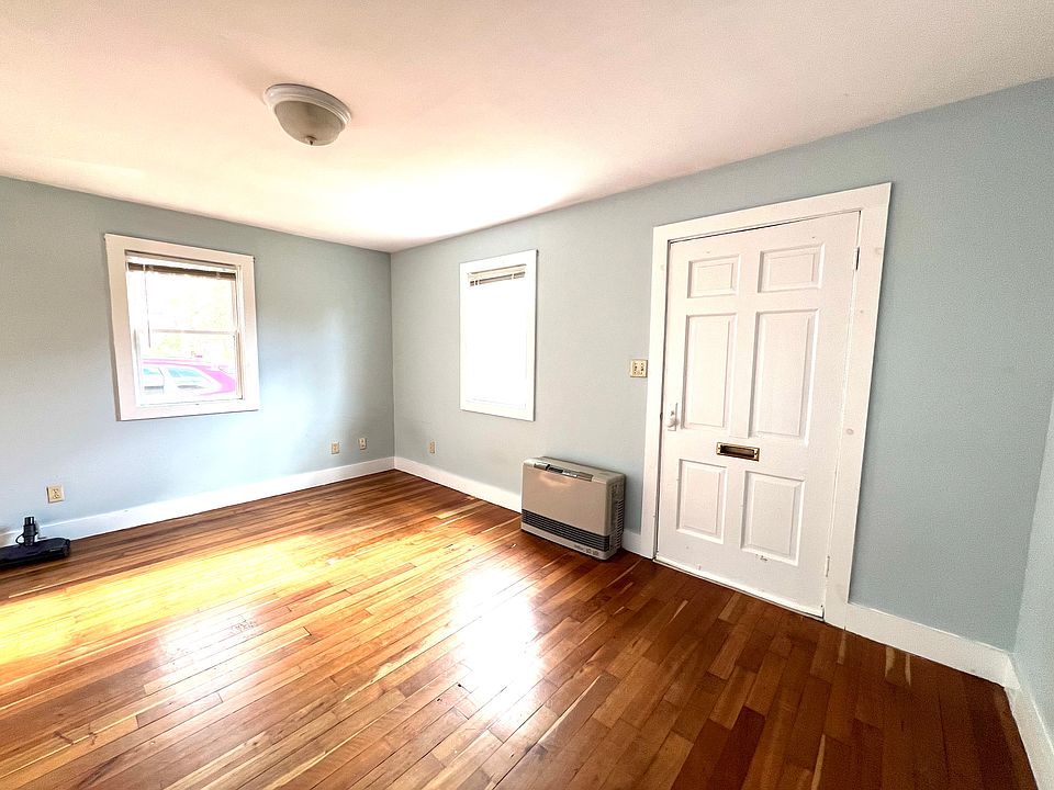 Sunny living room with original hardwood floors.
