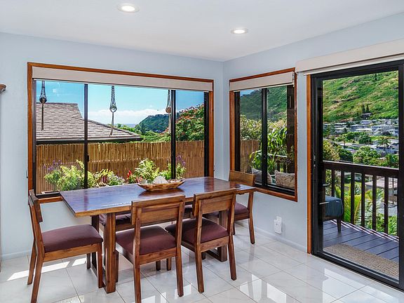 dining area; open floor plan flow from kitchen to living room and lanai with views