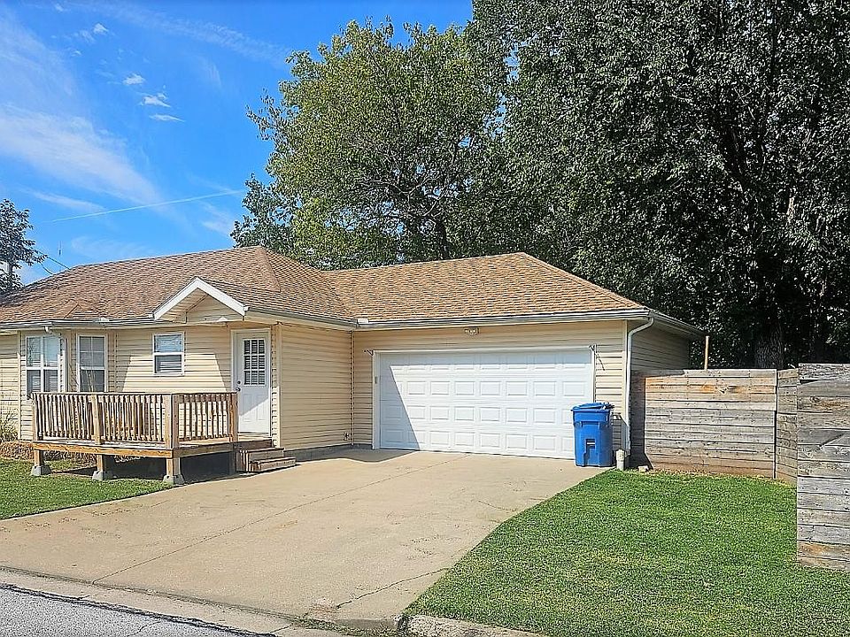 Side of house with garage and large side porch.