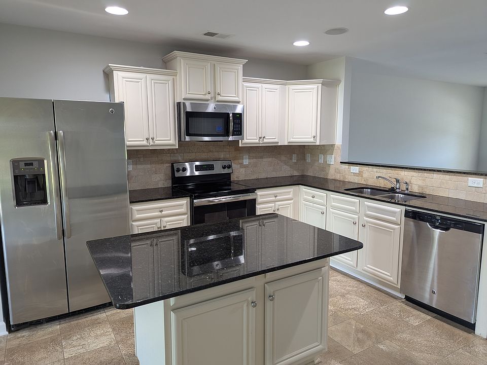 Kitchen with island and stainless appliances