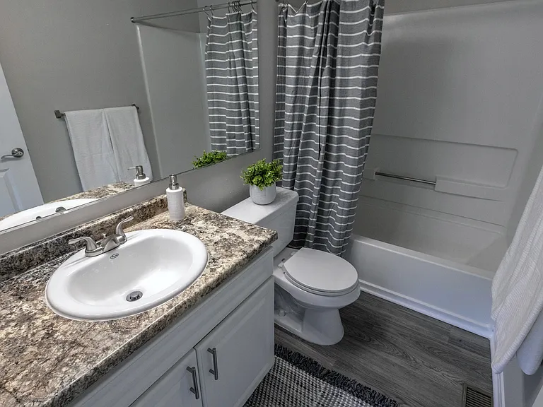 Indulge in bathrooms that radiate style. Savor the roomy vanity and contemporary aesthetics.