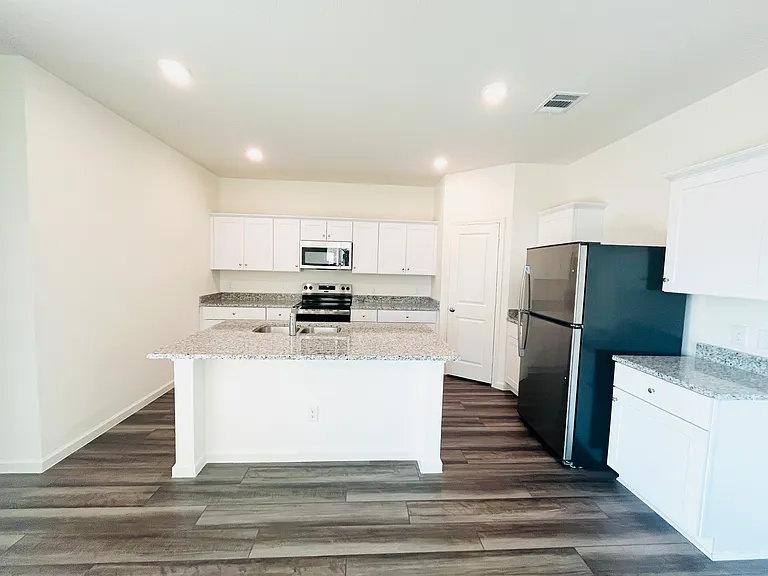 Kitchen with Refrigerator, Microwave, Stove and Oven