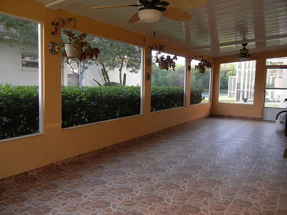400 sq feet covered, tiles, screened lanai overlook the pond.