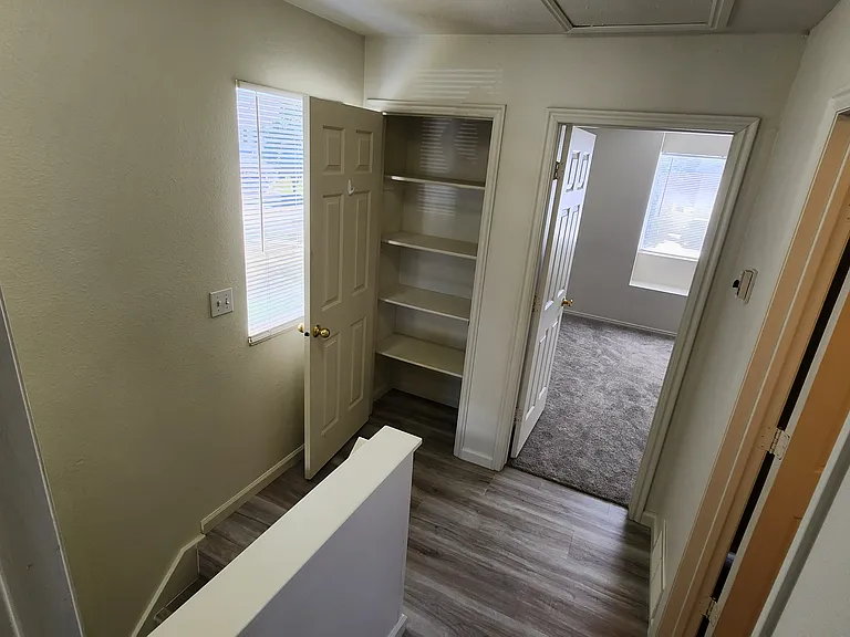 landing top of stairs looking into master bedroom, bathroom at right