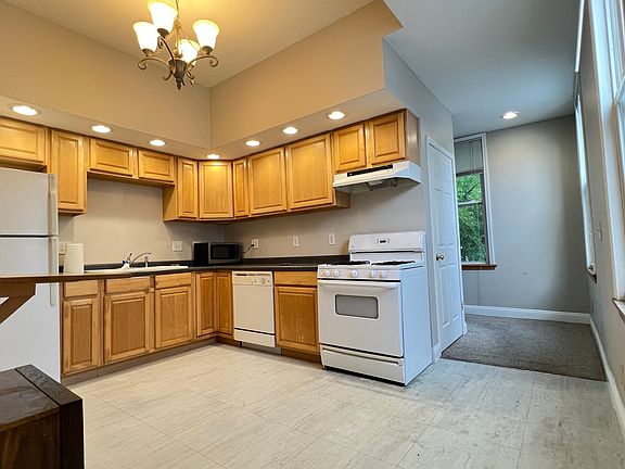 Kitchen with refrigerator, stove, microwave, and dishwasher