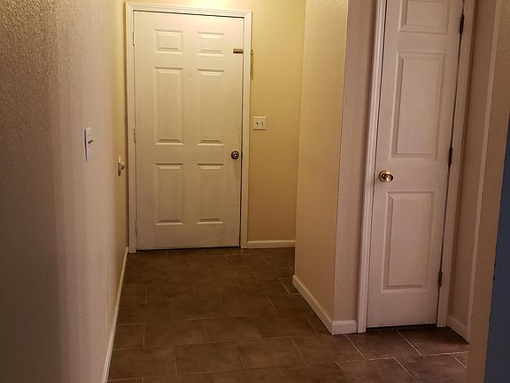 Entry showing the front door and ceramic tile and coat closet just outside the 1/2 bathroom