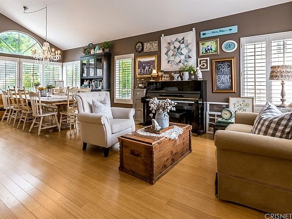 Open living room to dining with shutter on the win