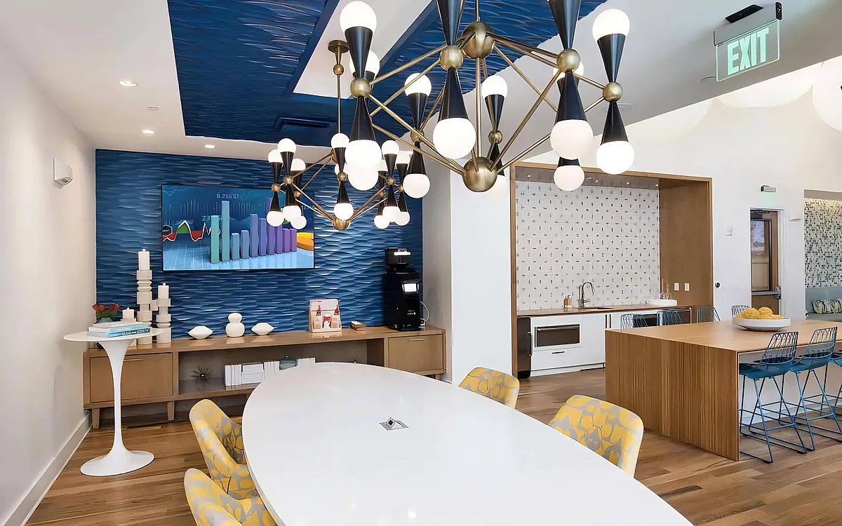 Community Lounge with TV, Coffee Station, and Modern Lighting Fixtures - Anchor Riverwalk