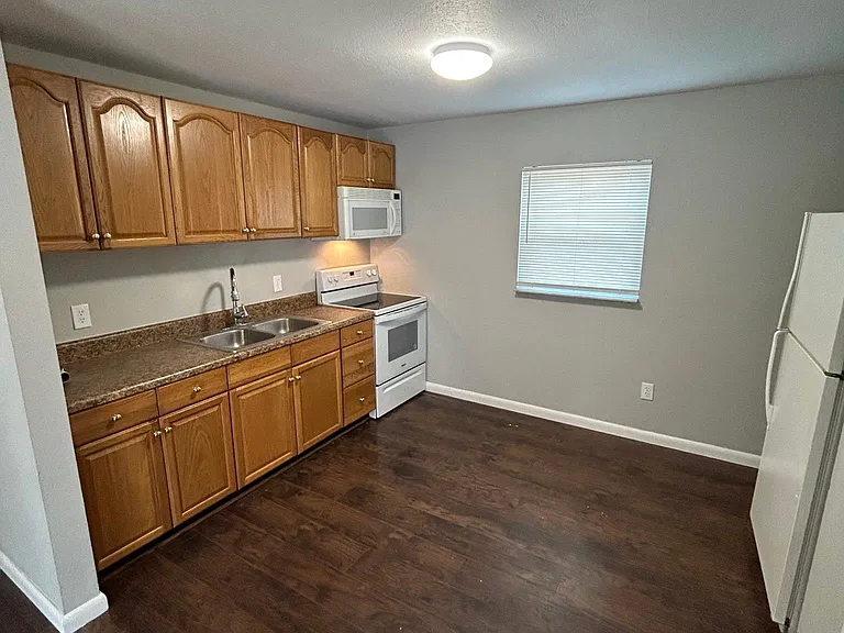 Kitchen: glass top stove, microwave hood, refrigerator w/ice maker, double stainless sink