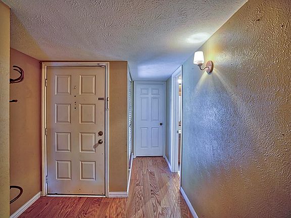 Wood flooring is carried throughout the entry and into the living and dining room.