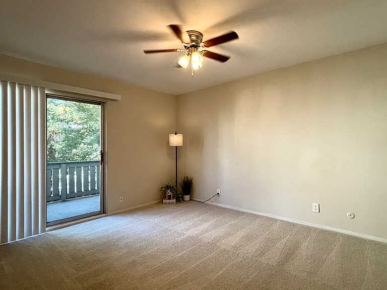 Unit: 211B
Primary bedroom with balcony and views of redwoods