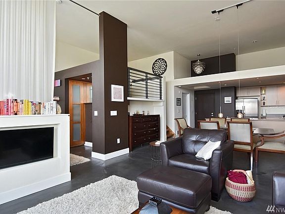 Living room to kitchen view . You can also see the loft upstairs.