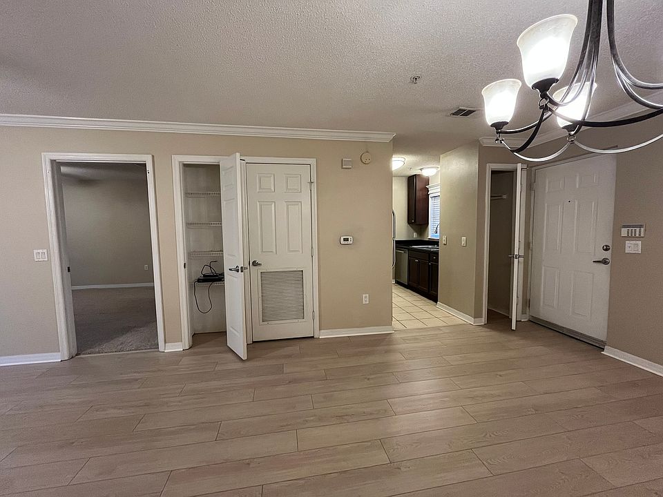 Dining area. From left to right there is the entrance to the Master Bedroom, a small Storage Closet, the A/C & Water Heater Closet, Entry to Kitchen, the Coat Closet and Front Door