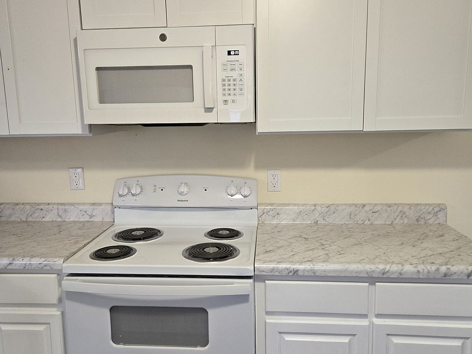 Kitchen with lots of new cabinets, counter tops, new stove and microwave