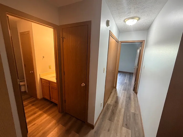Hallway to the 2nd bathroom, laundry and master bedroom