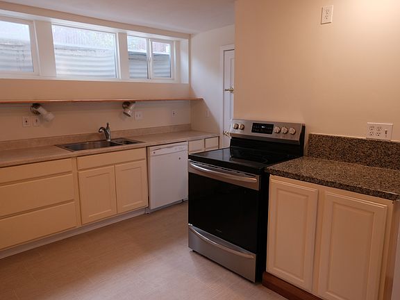 Kitchen with south-facing windows and pantry.