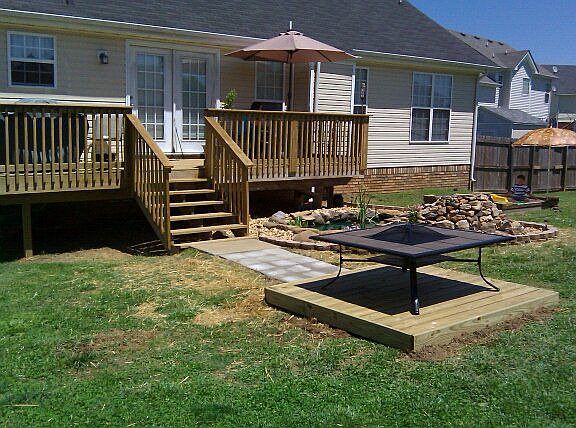 Rear of home, with new deck, koi pond, fire pit, and landscaping.