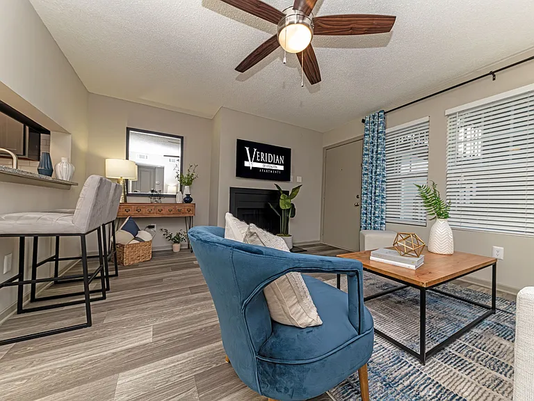Spacious living room with hardwood-style flooring throughout and overhead lighting