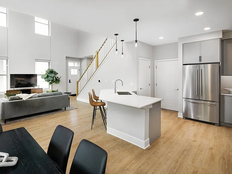 Signature Collection Townhome kitchen, dining, and living room with hard surface flooring