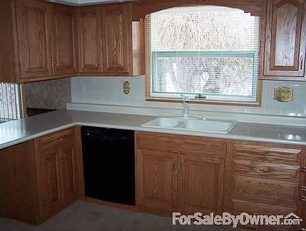 Remodeled U-shaped kitchen : New oak-faced cabinets, appliances include modular stove-top & double w