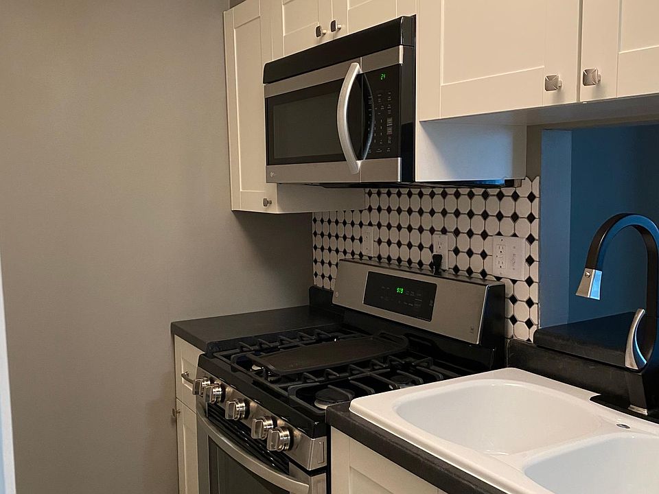 Kitchen with new 5 burner gas stove and new microwave