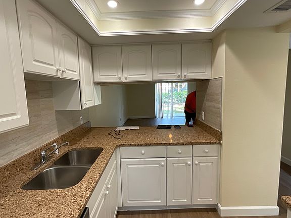 Kitchen with Tray Ceiling and Granite Countertops