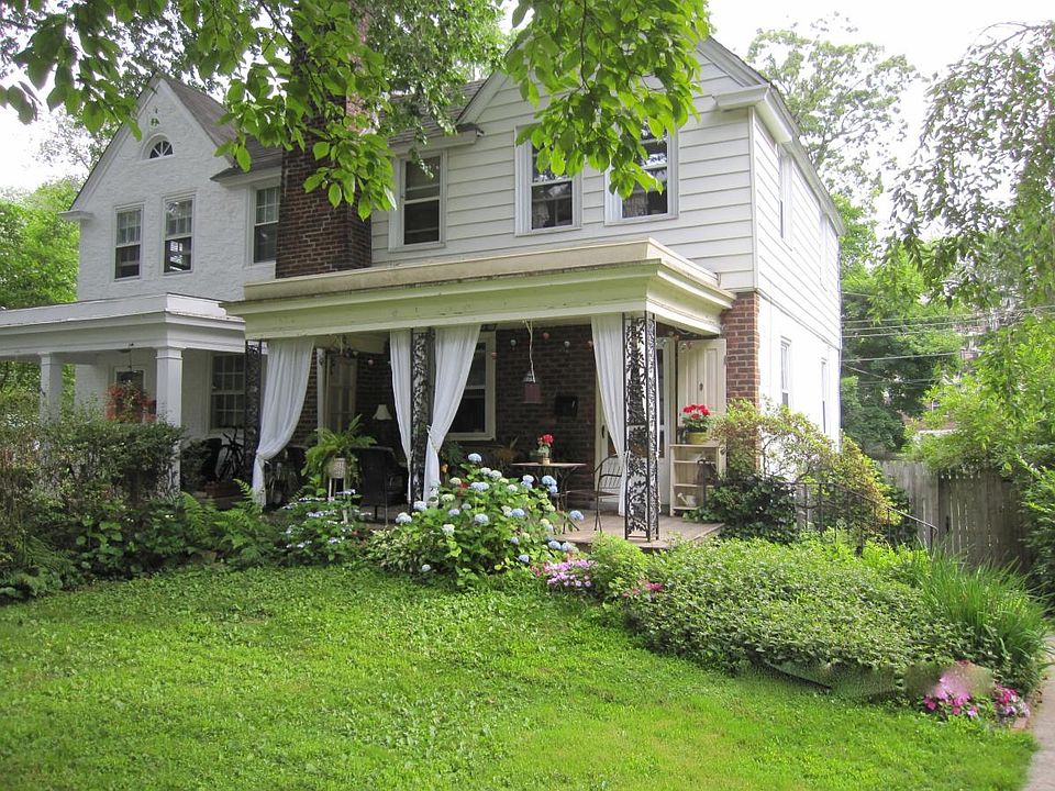 View of the property from the sidewalk. The curtains and furniture on the flagstone porch were a former tenant's.