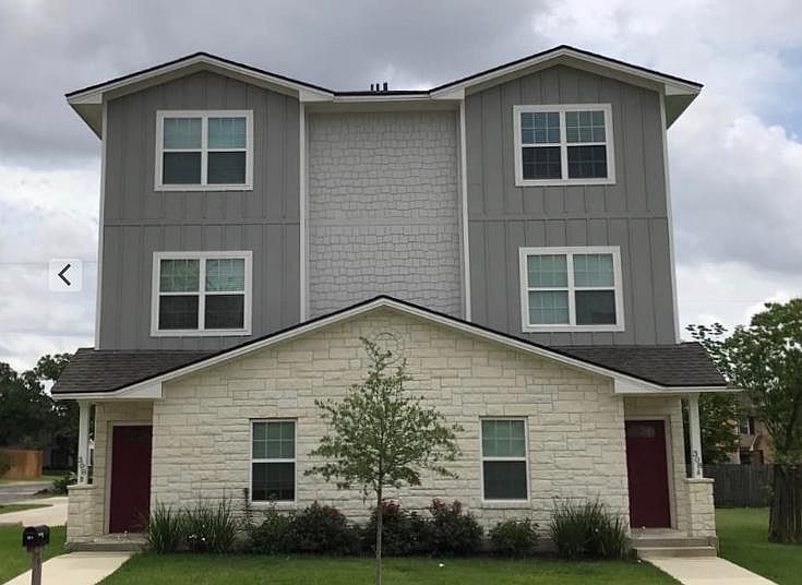 Front corner lot of duplex. Parking in paved parking lot in the rear.