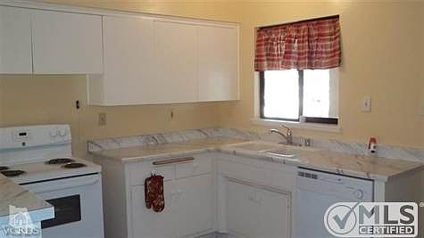 New kitchen counters & breakfast-bar top, new range, new sink & faucet, new dishwasher and garbage disposal and new easy-care vinyl flooring!  All cheerfully painted with white cupboards, drawers & appliances for an open/roomy feel!