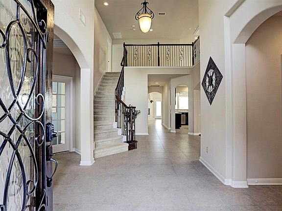 Enter this beautiful two story home through the upgraded front door which compliments the wrought iron spindles.