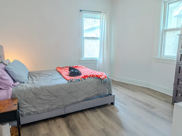 Expansive master bedroom with multiple windows.