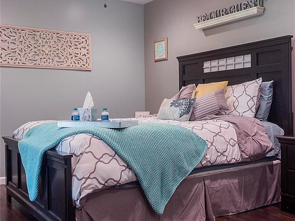 Your guests will love staying in this guest room in the lower level that features laminate flooring, custom walk-in closet, and 