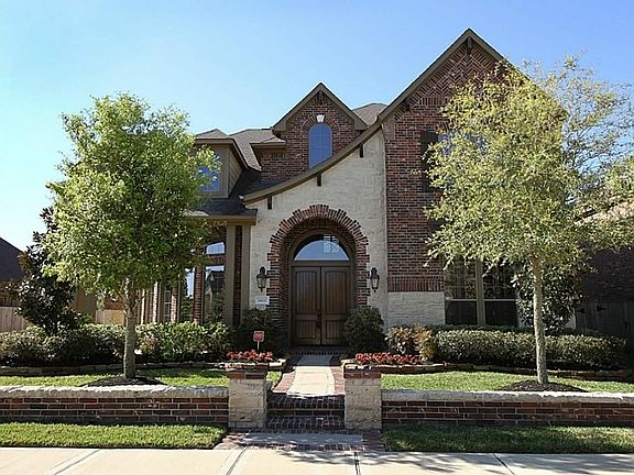 Front with stone elevation and covered porch
