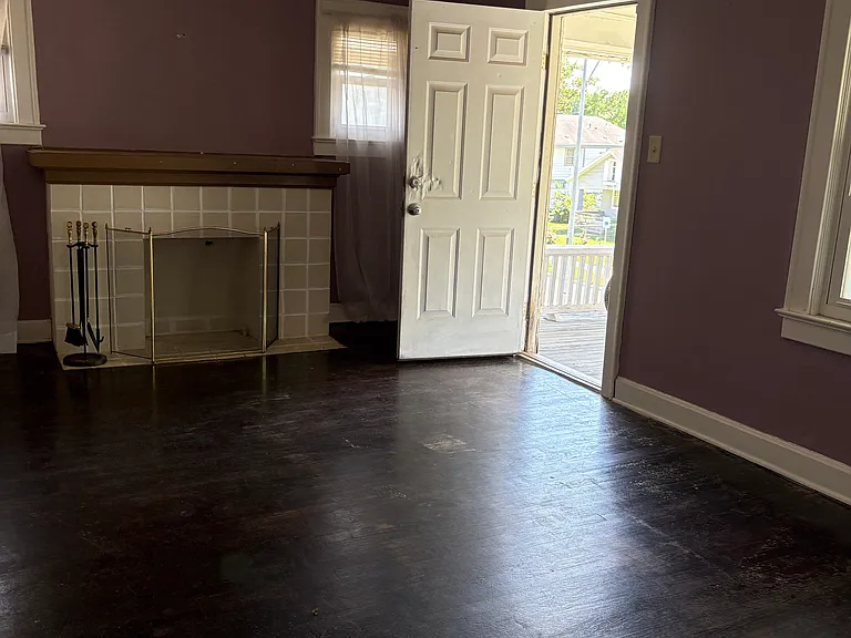 Living room with door open to the porch.