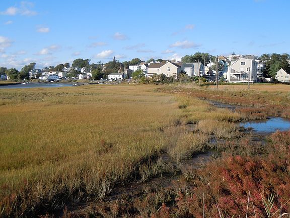 home in center background as seen from Belle Isle Marsh at low tide