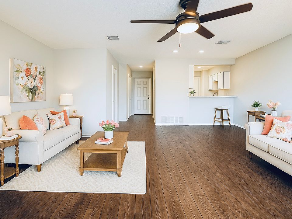 Bright and inviting living room with large windows and open layout, perfect for relaxing or entertaining.