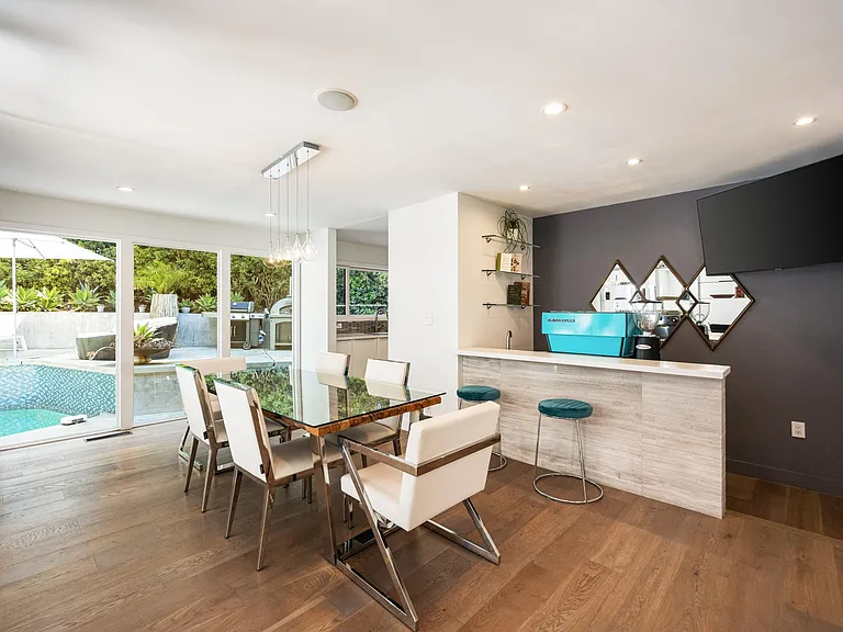 Dine in style at the elegant table, surrounded by chic decor and soft lighting.