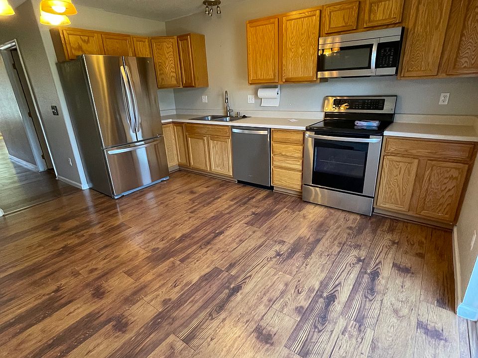 Eat in kitchen with new stainless steel dishwasher, microwave, oven and electric stove