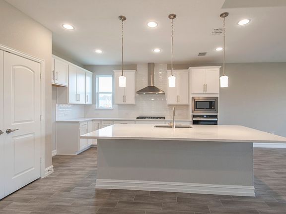 Pendant and recessed lighting in kitchen
